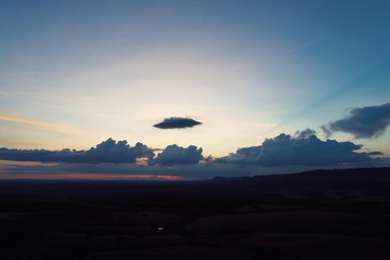 Aerial view of sunset in the countryside with a colored clouds. Explosion of colors in the sky.