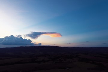 Aerial view of sunset in the countryside with a colored clouds. Explosion of colors in the sky.