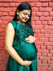 Maternity photo shoot of pregnant Indian woman as portrait