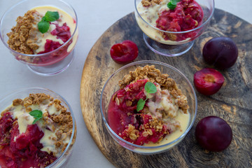 Fresh bright red plum crumble in the dessert bowl