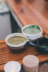 Japanese tea ceremony,Matcha tea prepared with bamboo whisk Flat lay matcha latte preparation concept.making matcha tea mix green powder in a mug on a background of coffee tools.