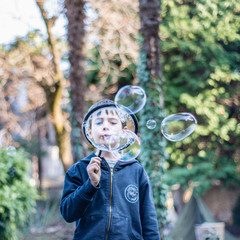 boy blowing soap bubbles