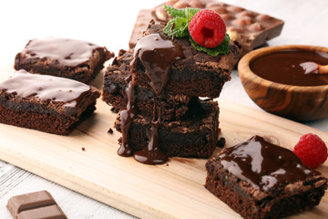 chocolate brownie cake dessert with raspberries and spices on a wooden background.