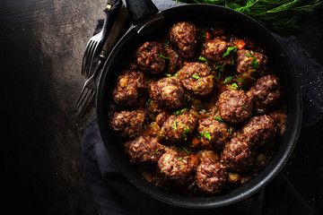 Fried meatballs with sauce on pan