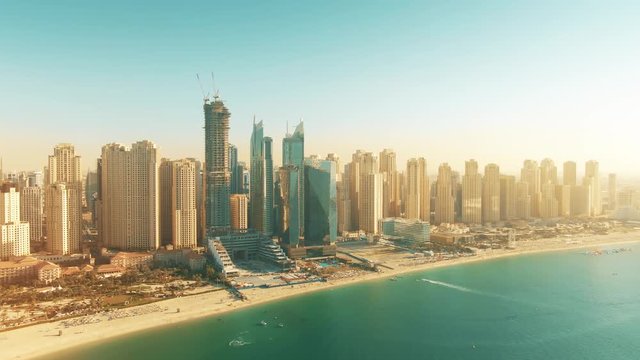 Aerial shot of Dubai Marina beach and skyscrapers on a sunny day, United Arab Emirates