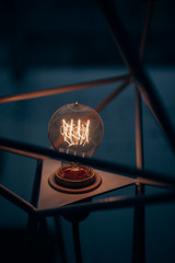 Electric lamp bulb in dark interior