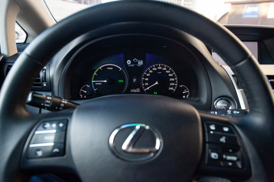  View to the black interior of Lexus RX450h Hybrid with dashboard, steering wheel and speedometer after cleaning before sale on parking