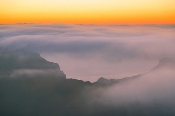 Landscape with mountains covered with clouds