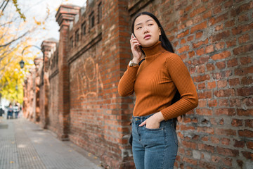 Asian woman talking on the phone.