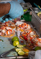 Preparation of shrimp tostadas at Ensenada's street tacos cart