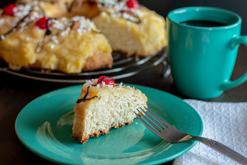 front view of portion of chocolate-dipped Easter thread with cherries and custard and a cup of coffee