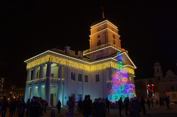 Naklejka premium Christmas neon city hall. New Year's luminous building. Minsk Belarus. December 31 2019