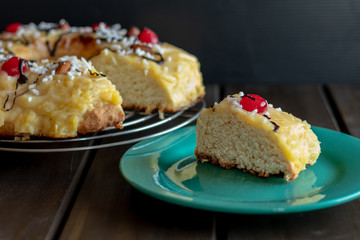 front view of portion of chocolate-dipped Easter thread with cherries and custard and a cup of coffee