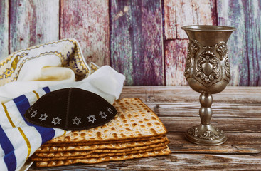 A Jewish Matzah bread and wine with kipah and tallit Passover holiday concept