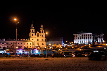 Obraz premium Christmas night neon glowing cityscape. Buildings with decorations and lamps. Minsk Belarus. December 31 2019