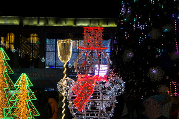 Christmas night neon glowing cityscape. Buildings with decorations and lamps. Minsk Belarus. December 31 2019
