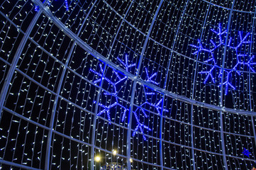 Christmas night neon glowing cityscape. Buildings with decorations and lamps. Minsk Belarus. December 31 2019