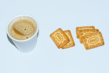 Hot beverage in foam cup with biscuits - white background
