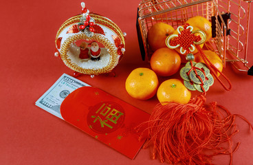 Celebrate Chinese New Year background with orange fruit and red envelope Ang Pau for U.S money