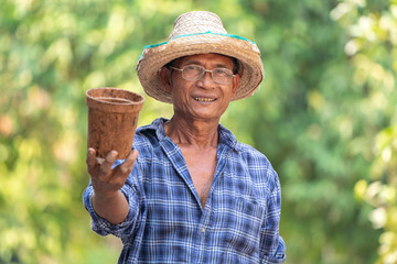 Fototapeta premium Asian farmer agriculture holding pot.