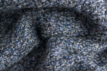 The closeup texture of cashmere things. Macro shot of knitted fabric from Lana Wool threads. Warm winter clothes. Background textile surface with copy space for text