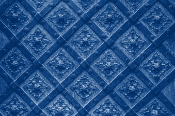 Old texture cathedral metal door in detail. Background Classic blue toning trend 2020