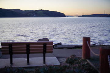 Fototapeta na wymiar bench by bay at sunset