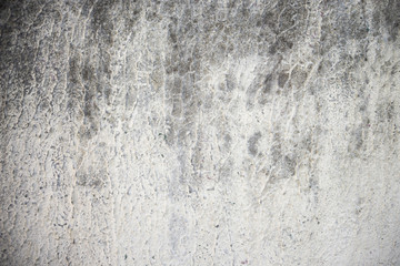 Texture of gray concrete wall whitewashed with traces of aging and dust.