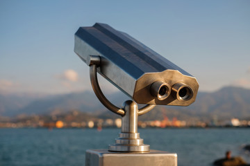 Public stationary binocular on sea shore