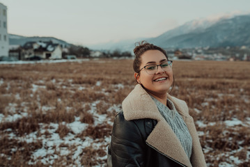 Portrait of afro woman in glasses on nature. Smile, positive, smart.