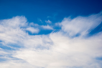 White clouds against the blue sky. Atmospheric phenomenon.