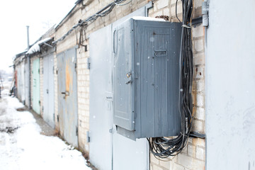 Old electrical communications box hanging on a wall in a garage cooperative