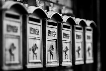 letter boxes in B&W waiting for customers