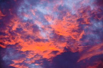 A very extraordinary and beautiful sunset in orange and purple colours, lightened and bright