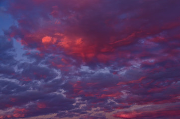 A very extraordinary and beautiful sunset in orange and purple colours, lightened and bright
