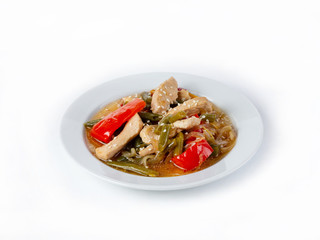 Thick chicken soup with vegetables sprinkled with sesame seeds on a white background, side view