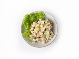 Salad with ham, green peas, potatoes, carrots, dressed with mayonnaise, top view
