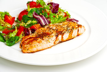grilled salmon steak with vegetables and sauce