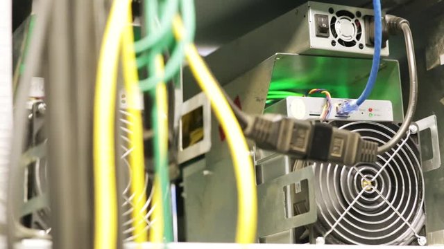 IT professionals concept. Stock footage. Close-up of data center of the large company with lots of fans, system units and wires.