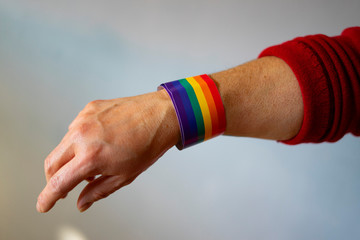 Woman with a bracelet with the pride flag.