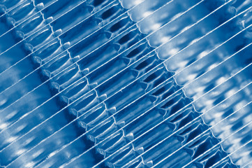 Details of the car engine radiator. Macro close-up of the radiator plates. in classic blue trendy color of the year 2020