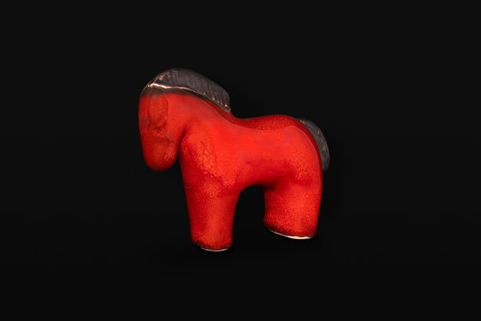 Decorative ceramic horse on black background