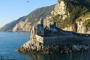 Naklejka premium Church of San Pietro in Portovenere on the rocks overlooking the sea. Ancient medieval building near the Cinque Terre in Liguri. Italy..