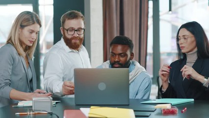 Group of multi-ethnic co-workers gathered together working discuss current issues common tasks african team leader talk with colleague business workplace skilled technology slow motion