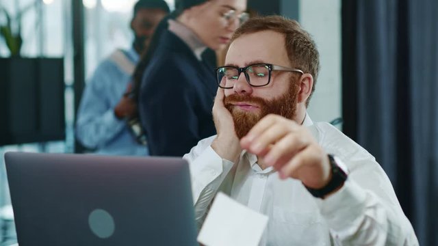 Tired business man touching head working hard on laptop upset exhausted young office work worried sleepy stressed frustrated employee corporate computer career businessman slow motion