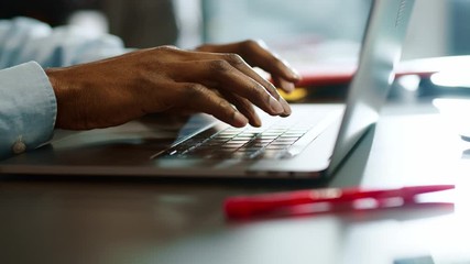 Close up hands man african american young uses laptop typing touch work in office programmer sunlight business sucess slow motion - Powered by Adobe
