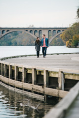Couple holding hands and walking along the boardwalk in Georgetown, Washington DC - 312688788