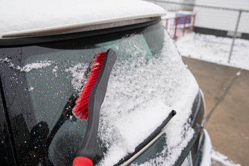 snow brush cleans snow from the back window of your car