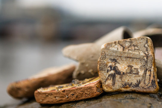 Close up of a detailed country scene on an old piece of pottery, found while mudlarking on the River Thames in London, UK