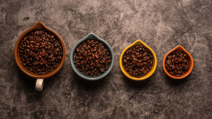 Fresh raw organic coffee beans on a dark background.